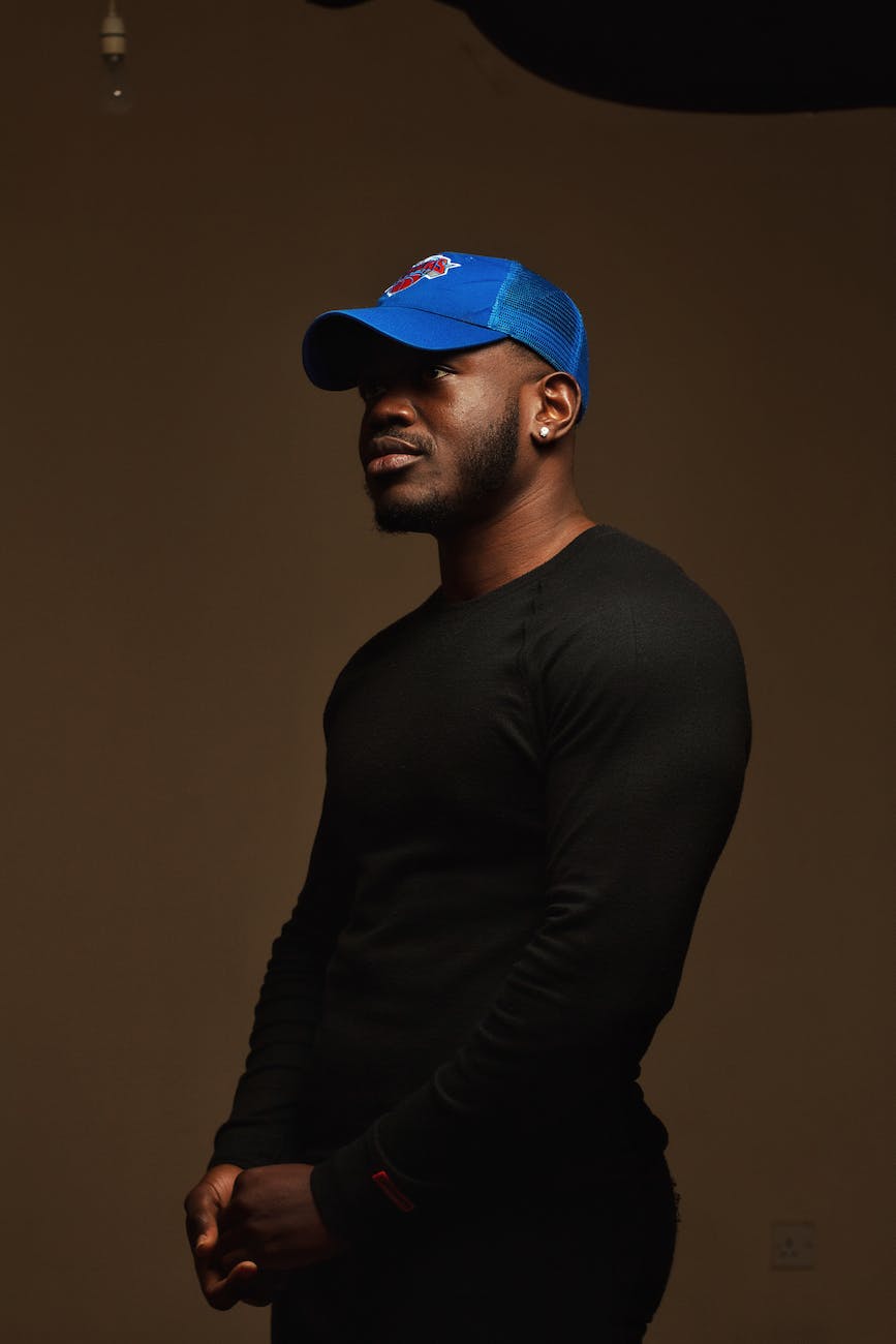 a man in black long sleeves and blue cap